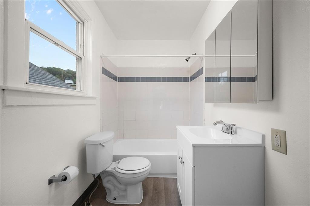 1128 9th Street McKees Rocks, PA 15136 - Photo 21 of 33 a white toilet sitting next to a bathroom sink