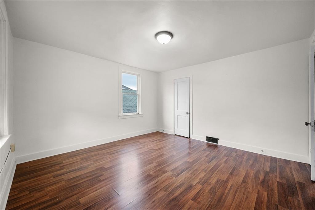 1128 9th Street McKees Rocks, PA 15136 - Photo 23 of 33 an empty room with wooden floor and windows