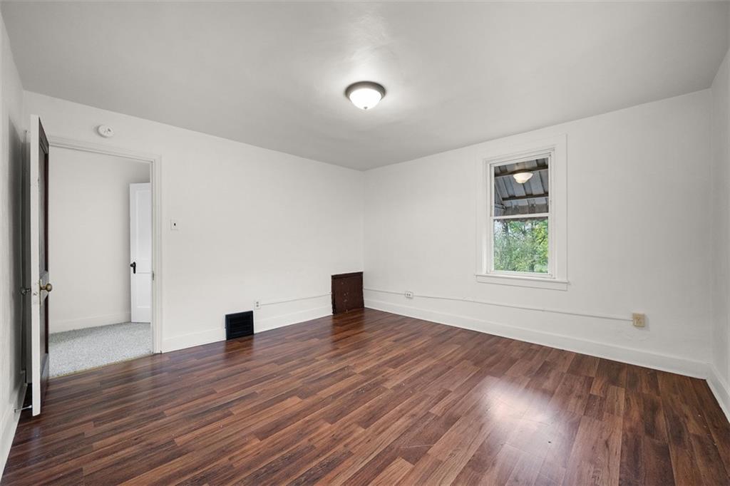 1128 9th Street McKees Rocks, PA 15136 - Photo 24 of 33 an empty room with wooden floor and windows