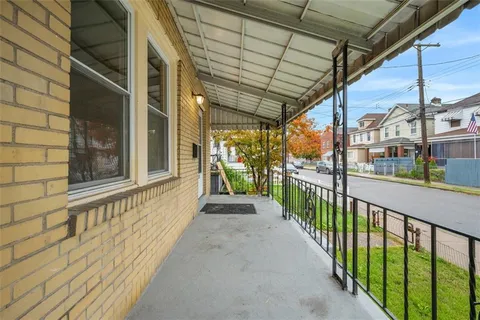 a view of a porch with wooden floor and stairs