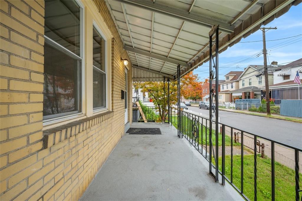 1128 9th Street McKees Rocks, PA 15136 - Photo 3 of 33 a view of a porch with wooden floor and stairs