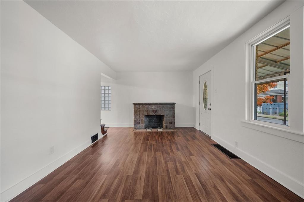1128 9th Street McKees Rocks, PA 15136 - Photo 8 of 33 wooden floor fireplace and windows in an empty room