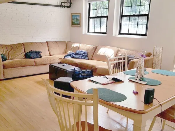 a living room with furniture and two window