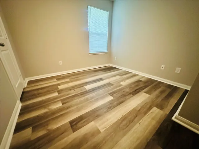a bathroom with a granite countertop sink a toilet a mirror and shower