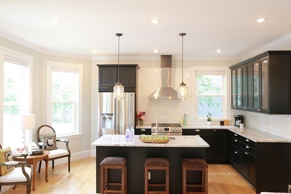 40 Evergreen Avenue, Unit 1 Somerville, MA 02145 - Photo 1 of 24 a room with stainless steel appliances kitchen island granite countertop a table chairs in it and a window