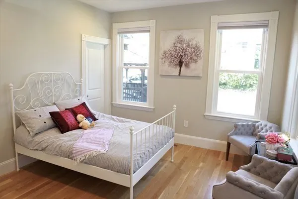 a bedroom with a large bed and a window