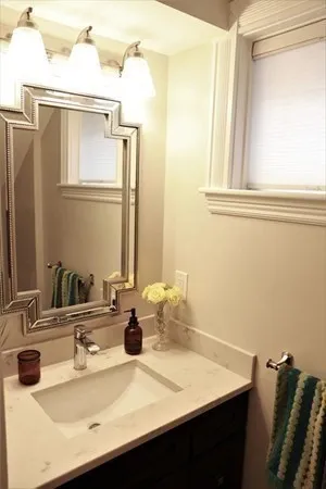 a bathroom with a sink vanity and a mirror