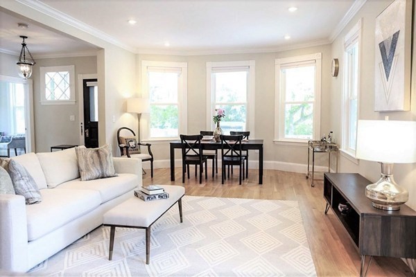 40 Evergreen Avenue, Unit 1 Somerville, MA 02145 - Photo 3 of 24 a living room with furniture a dining table and a large window