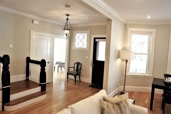 a living room with furniture a window and a chandelier