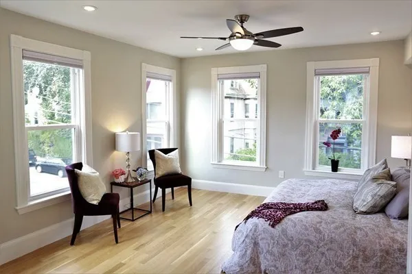 a bedroom with a bed and a chair