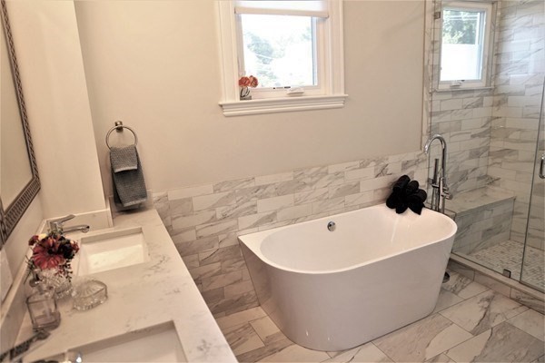 40 Evergreen Avenue, Unit 1 Somerville, MA 02145 - Photo 7 of 24 a white bath tub sitting in a bathroom