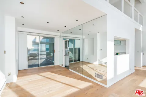 a view of a room with wooden floor and windows