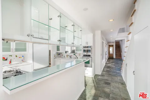a view of a kitchen with kitchen appliances