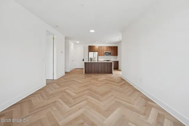 a view of kitchen with refrigerator and window