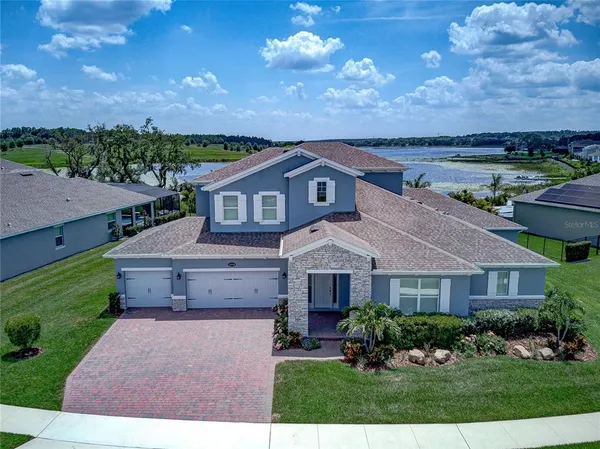 an aerial view of a house with outdoor space and lake view