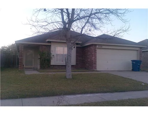 a house that has a tree in front of it