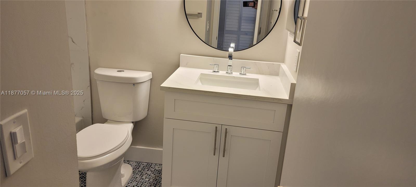 4829 Sable Pine Circle, Unit C1 West Palm Beach, FL 33417 - Photo 12 of 13 a bathroom with a sink a toilet and a mirror