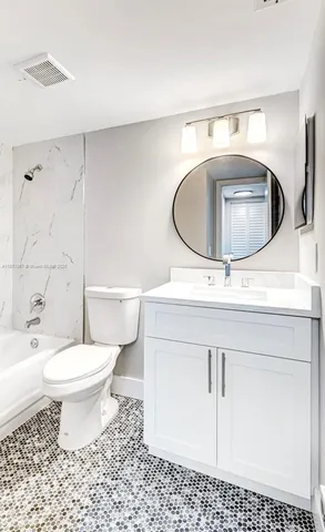 a bathroom with a sink toilet and a mirror