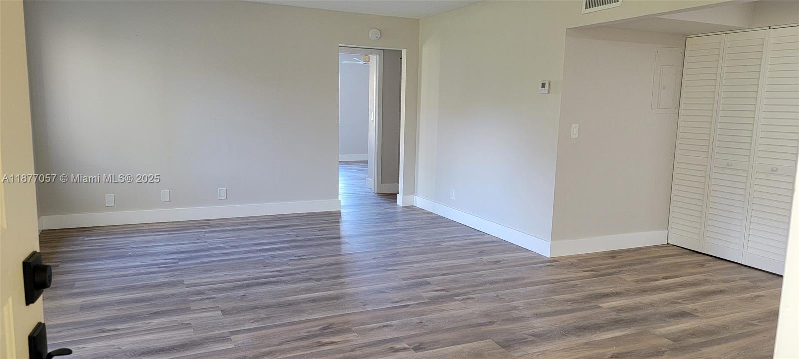 4829 Sable Pine Circle, Unit C1 West Palm Beach, FL 33417 - Photo 7 of 13 a view of a hallway with wooden floor