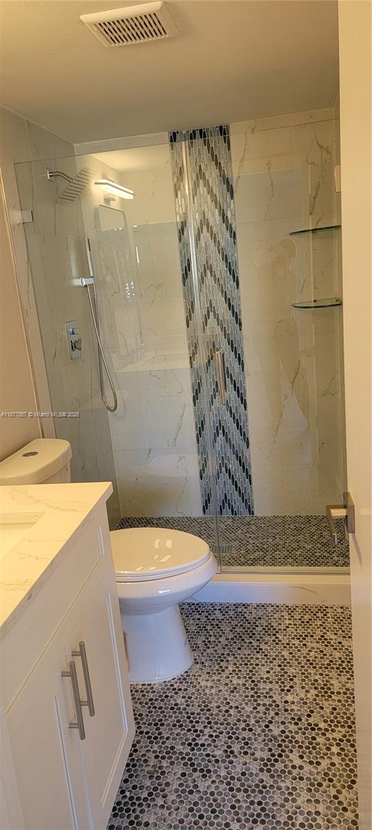 4829 Sable Pine Circle, Unit C1 West Palm Beach, FL 33417 - Photo 10 of 13 a bathroom with a sink a toilet and shower