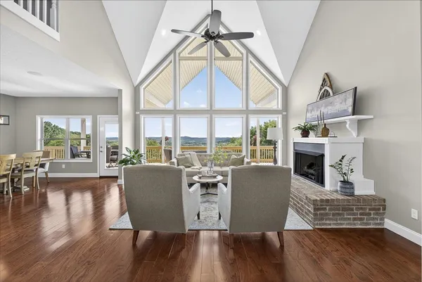 a living room with fireplace furniture and a large window
