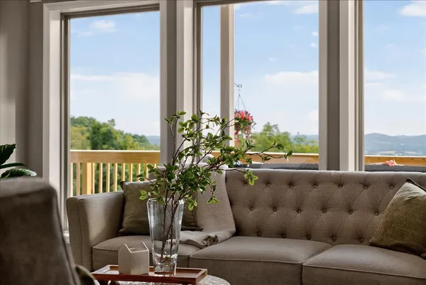 a spacious bedroom with a bed and large window with wooden floor