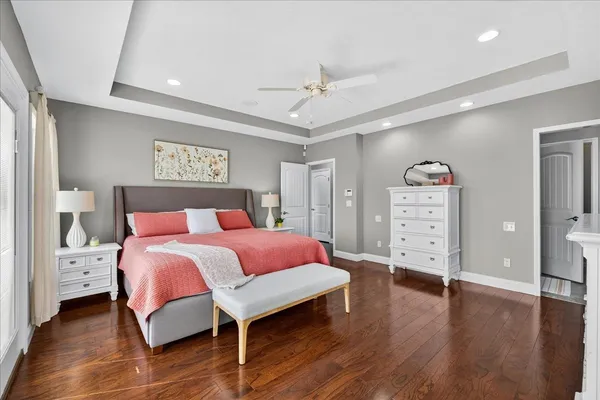 a bedroom with a large bed and a potted plant