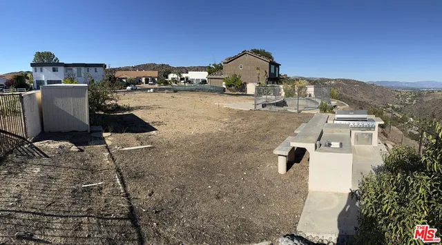 an aerial view of a house with a yard and sitting space