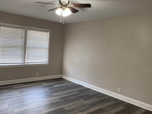 5709 Beechnut Street Houston, TX 77074 - Photo 12 of 15 an empty room with wooden floor and windows