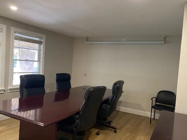 a view of a workspace with furniture and a chair