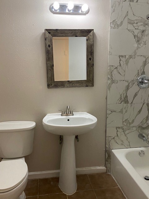 5709 Beechnut Street Houston, TX 77074 - Photo 7 of 15 a bathroom with a sink a toilet and bathtub