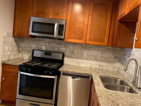 a kitchen with a stove microwave and sink