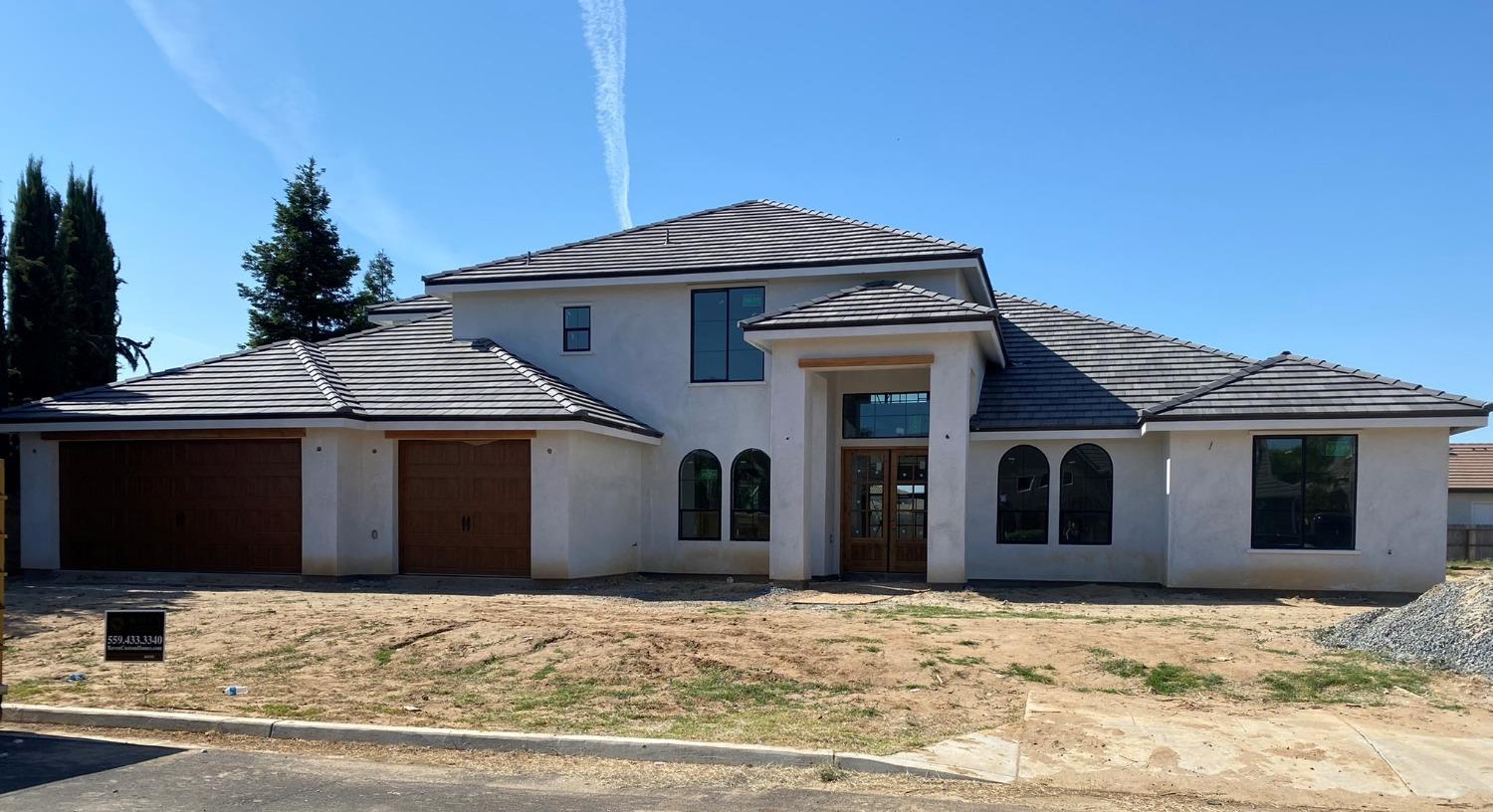 3076 Lester Avenue Clovis, CA 93619 - Photo 1 of 47 a front view of a house with a yard