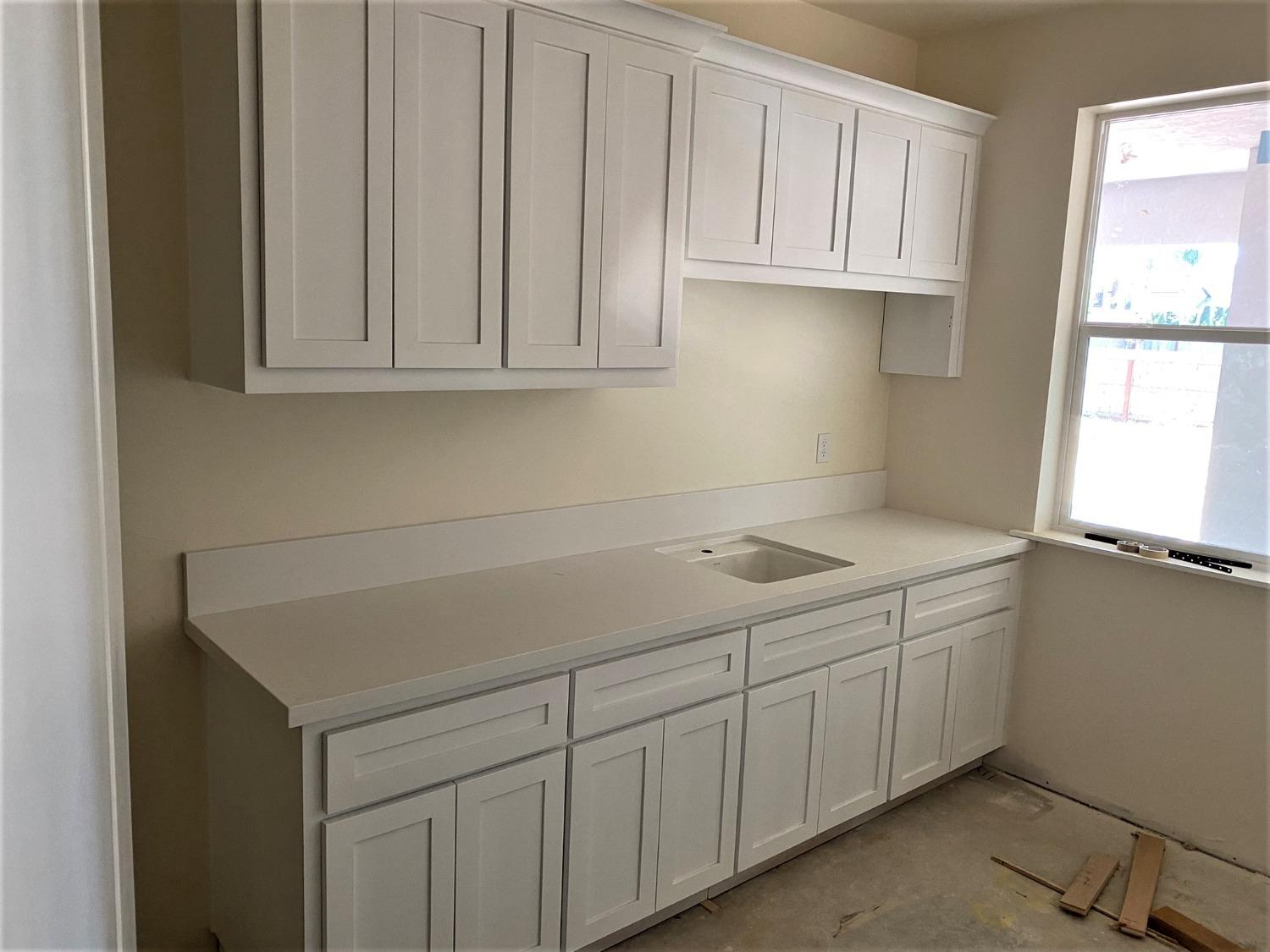 3076 Lester Avenue Clovis, CA 93619 - Photo 16 of 47 a room with a sink cabinets and a window