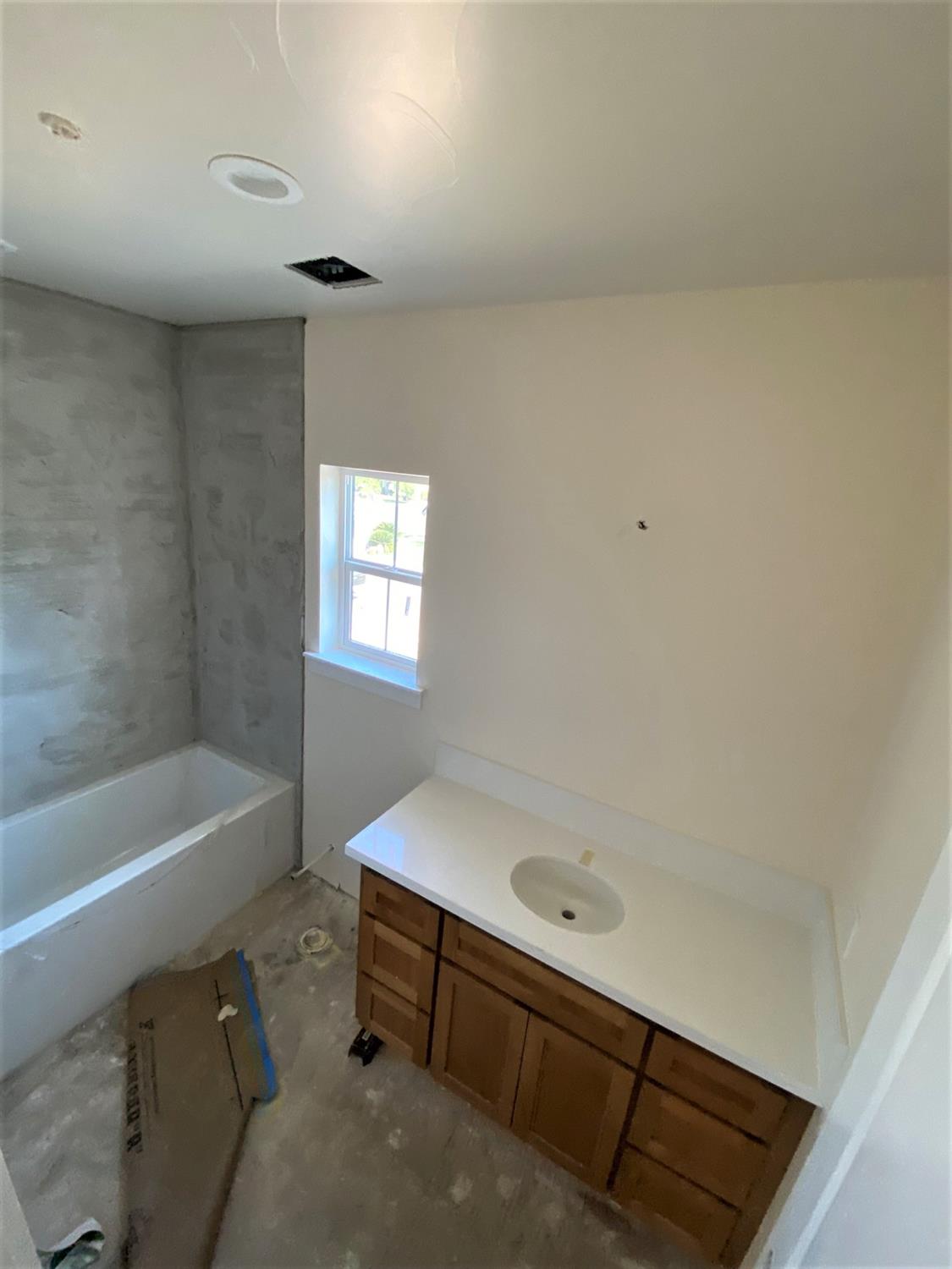 3076 Lester Avenue Clovis, CA 93619 - Photo 25 of 47 a bathroom with a bathtub and a shower
