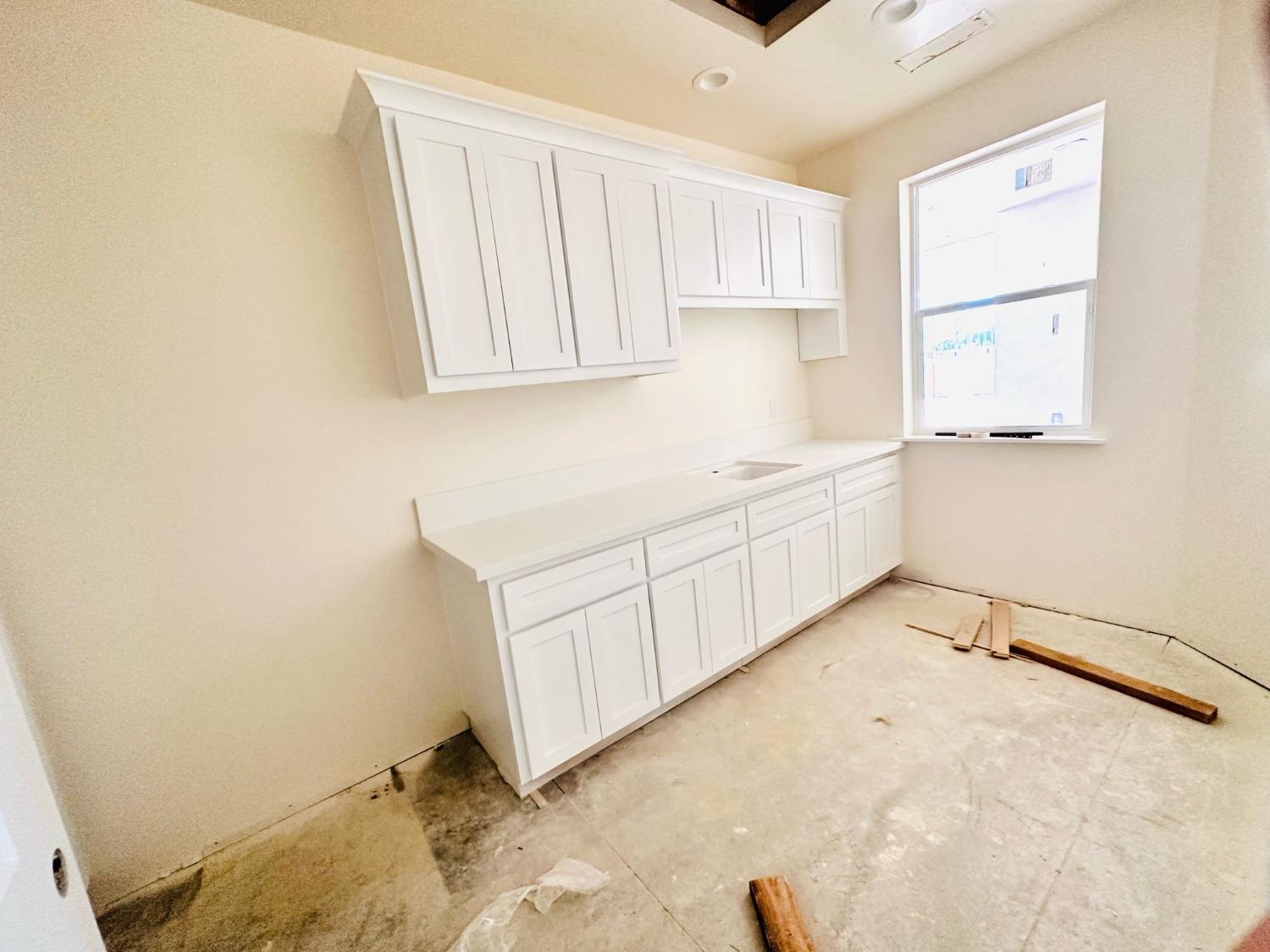 3076 Lester Avenue Clovis, CA 93619 - Photo 36 of 47 a view of a kitchen with white cabinets
