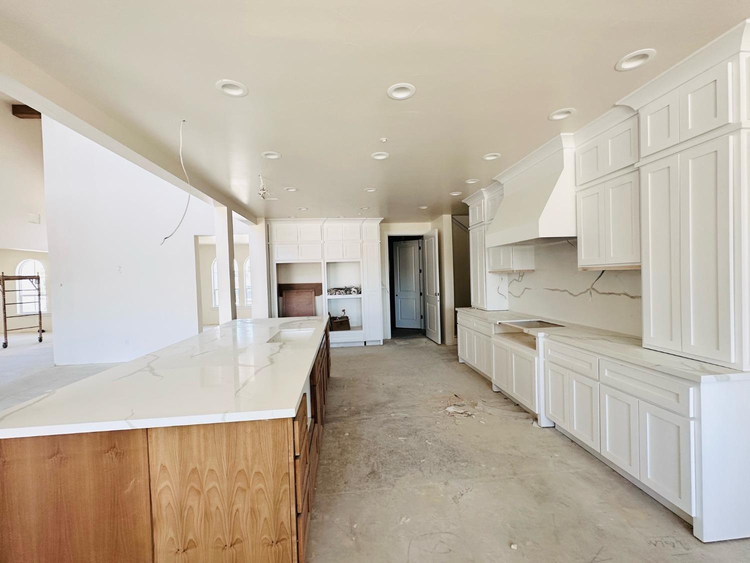 3076 Lester Avenue Clovis, CA 93619 - Photo 6 of 47 a large kitchen with a large counter top appliances and cabinets