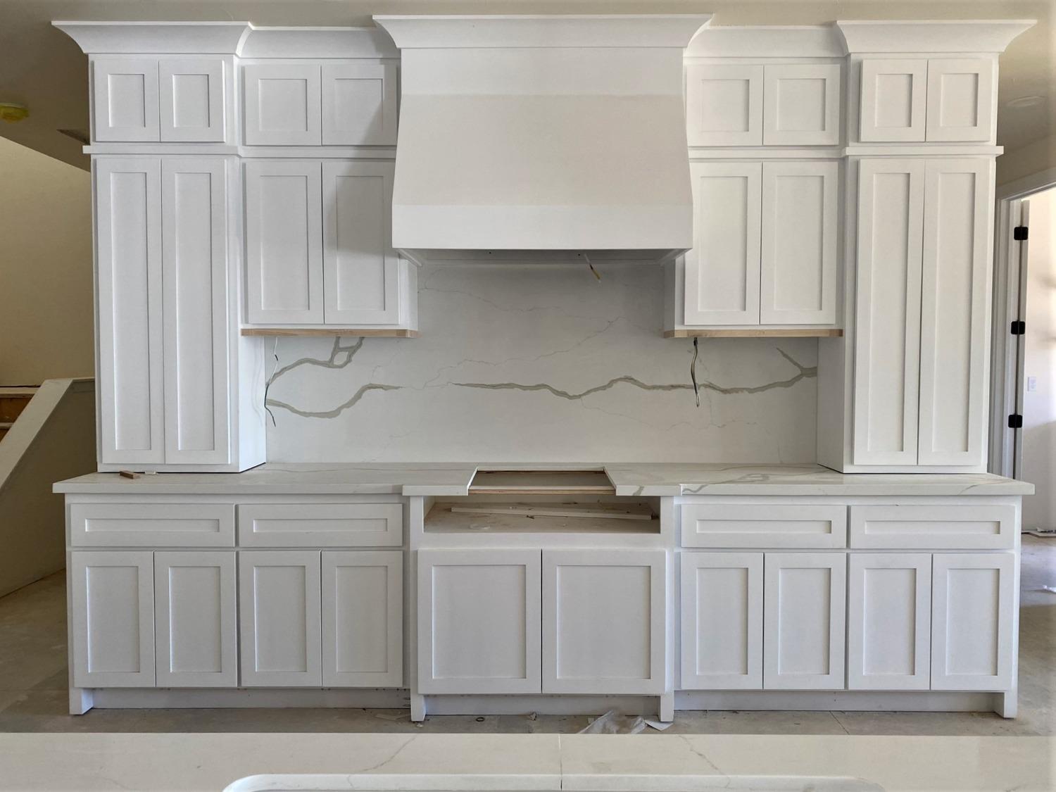 3076 Lester Avenue Clovis, CA 93619 - Photo 7 of 47 a kitchen with white cabinets and a sink