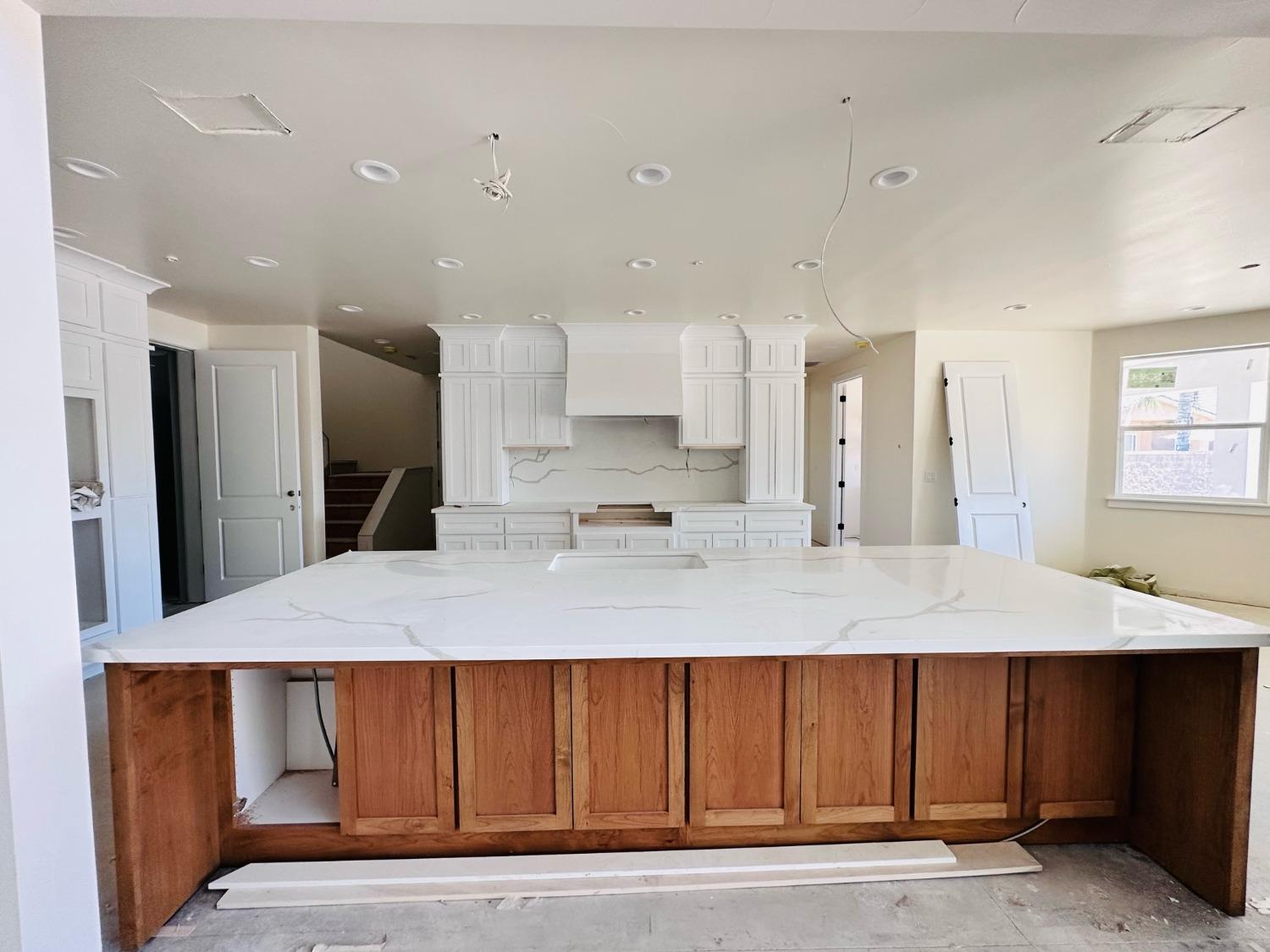 3076 Lester Avenue Clovis, CA 93619 - Photo 8 of 47 a large kitchen with kitchen island a sink stainless steel appliances and cabinets
