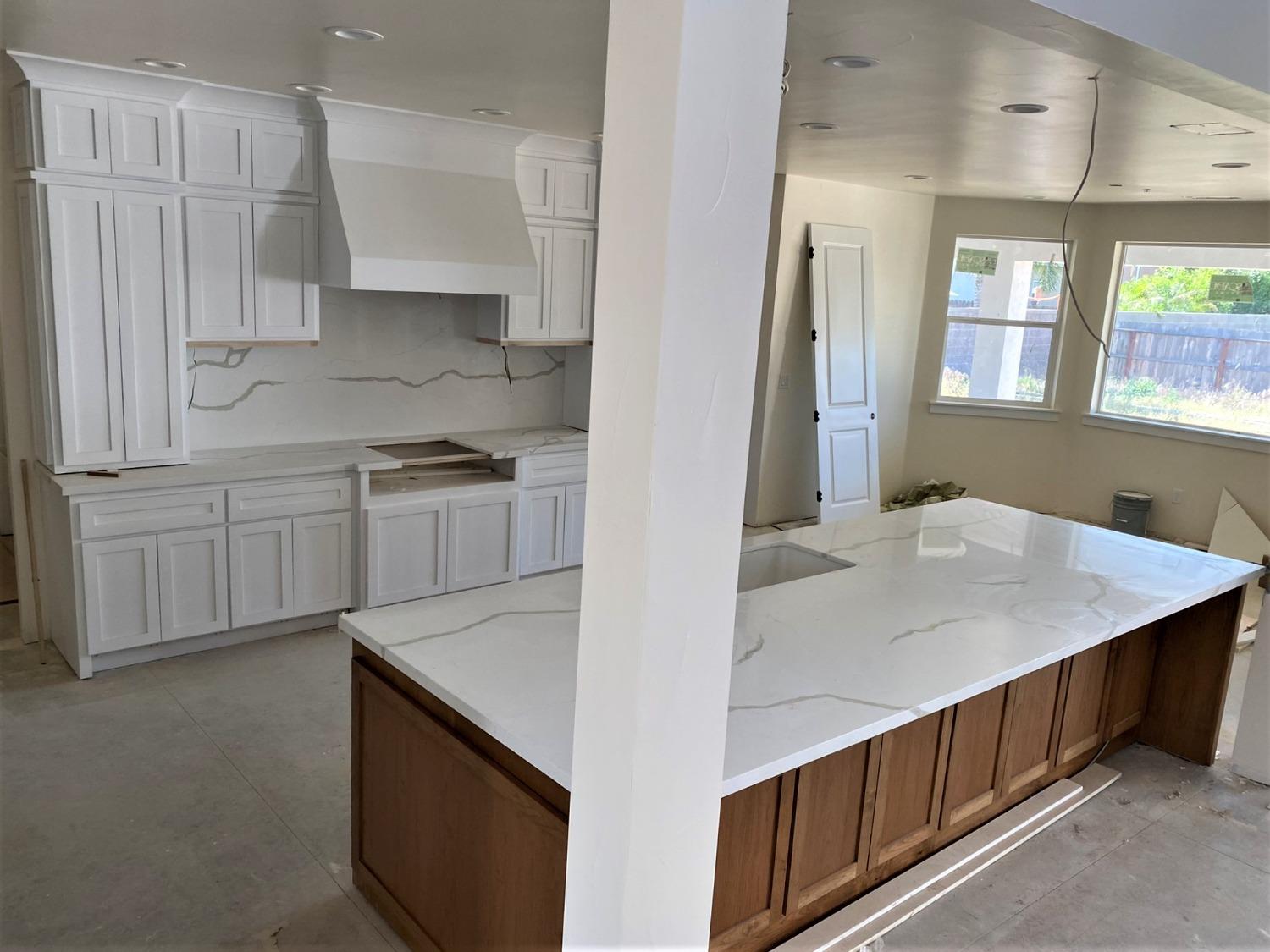 3076 Lester Avenue Clovis, CA 93619 - Photo 9 of 47 a kitchen that has a sink and a stove in it