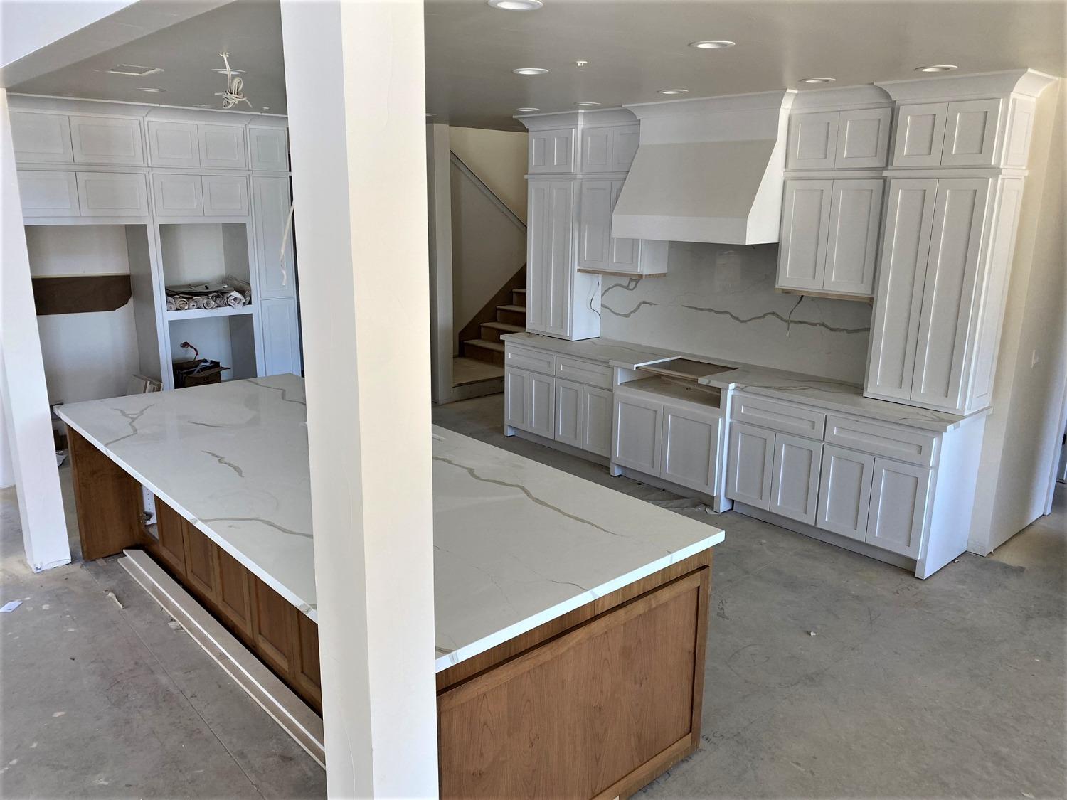 3076 Lester Avenue Clovis, CA 93619 - Photo 10 of 47 a kitchen with stainless steel appliances granite countertop a sink a stove and a refrigerator