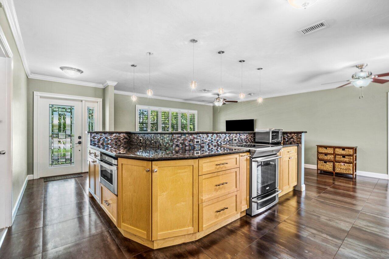 105 Orchard Ridge Lane Boca Raton, FL 33431 - Photo 8 of 37 a kitchen with stainless steel appliances granite countertop a stove and a sink