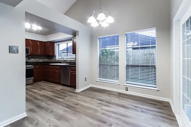 a view of kitchen with window and stainless steel appliances