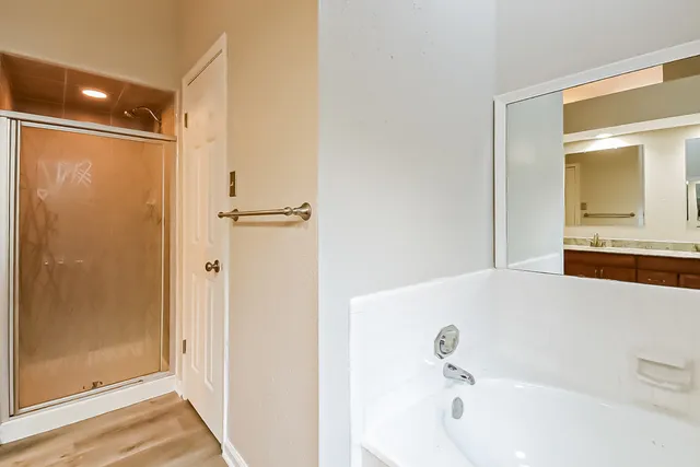 a bathroom with a bathtub and a shower