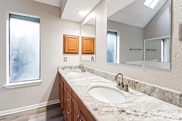 a bathroom with a granite countertop sink a mirror and