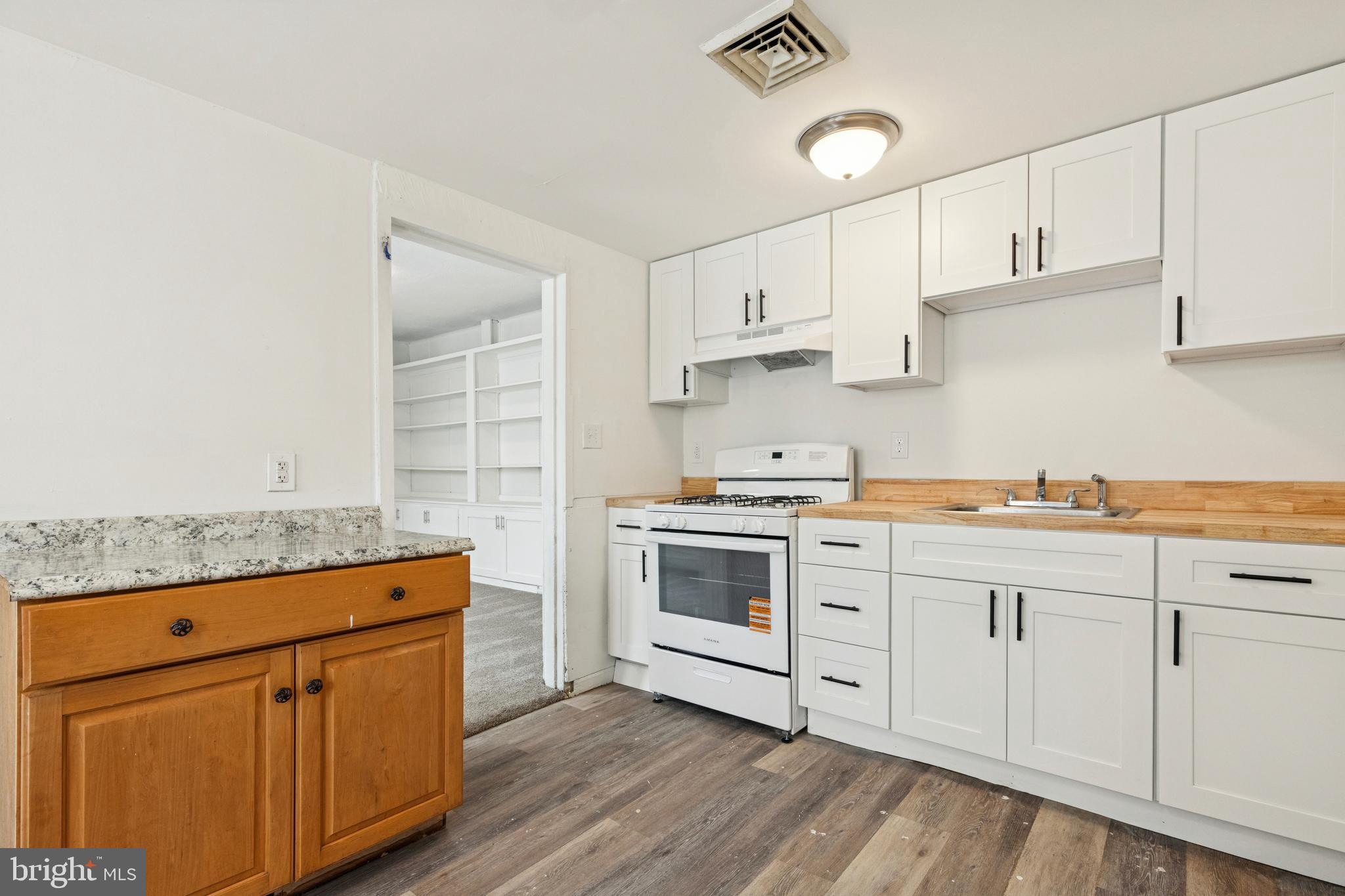 415 Walnut Street Pottstown, PA 19464 - Photo 6 of 15 a kitchen with granite countertop white cabinets and white appliances