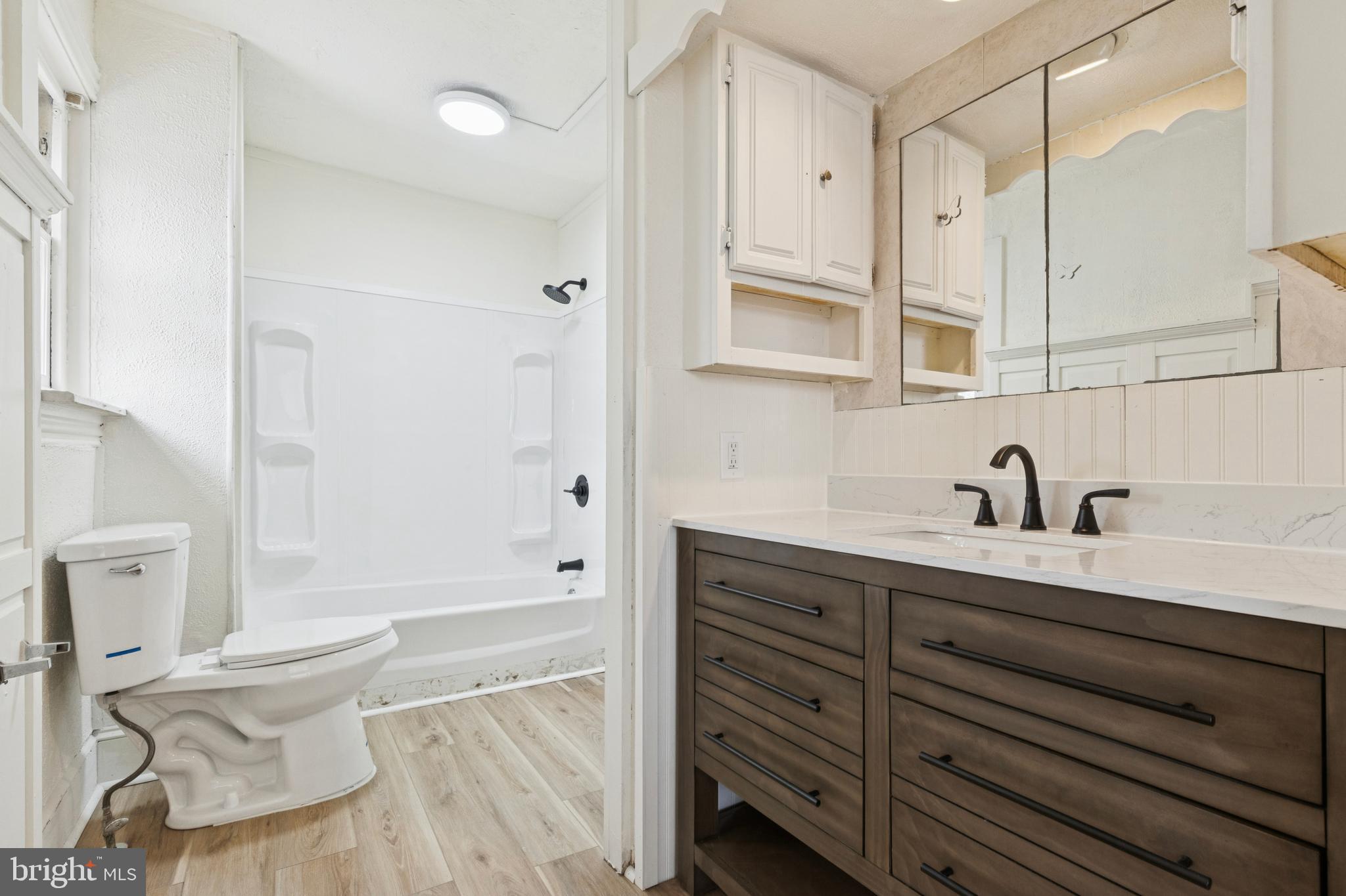 415 Walnut Street Pottstown, PA 19464 - Photo 9 of 15 a spacious bathroom with a granite countertop sink a toilet and shower