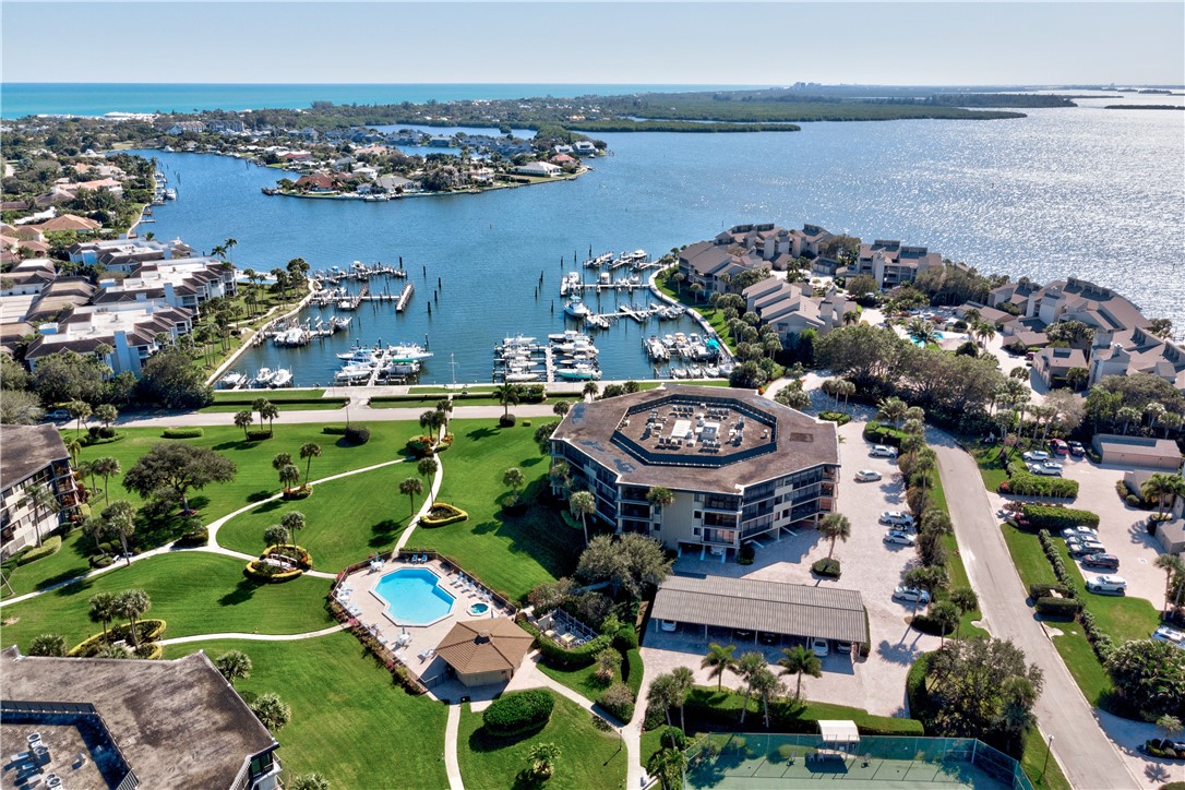 1850 Bay Road, Unit 2C Vero Beach, FL 32963 - Photo 1 of 36 an aerial view of a house with a garden and lake view