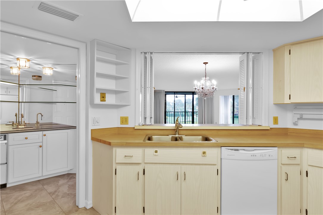 1850 Bay Road, Unit 2C Vero Beach, FL 32963 - Photo 11 of 36 a bathroom with a sink and a mirror