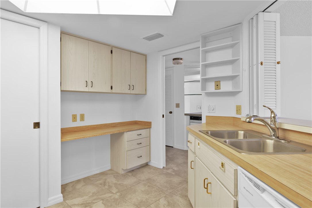 1850 Bay Road, Unit 2C Vero Beach, FL 32963 - Photo 13 of 36 a kitchen with granite countertop a sink and cabinets